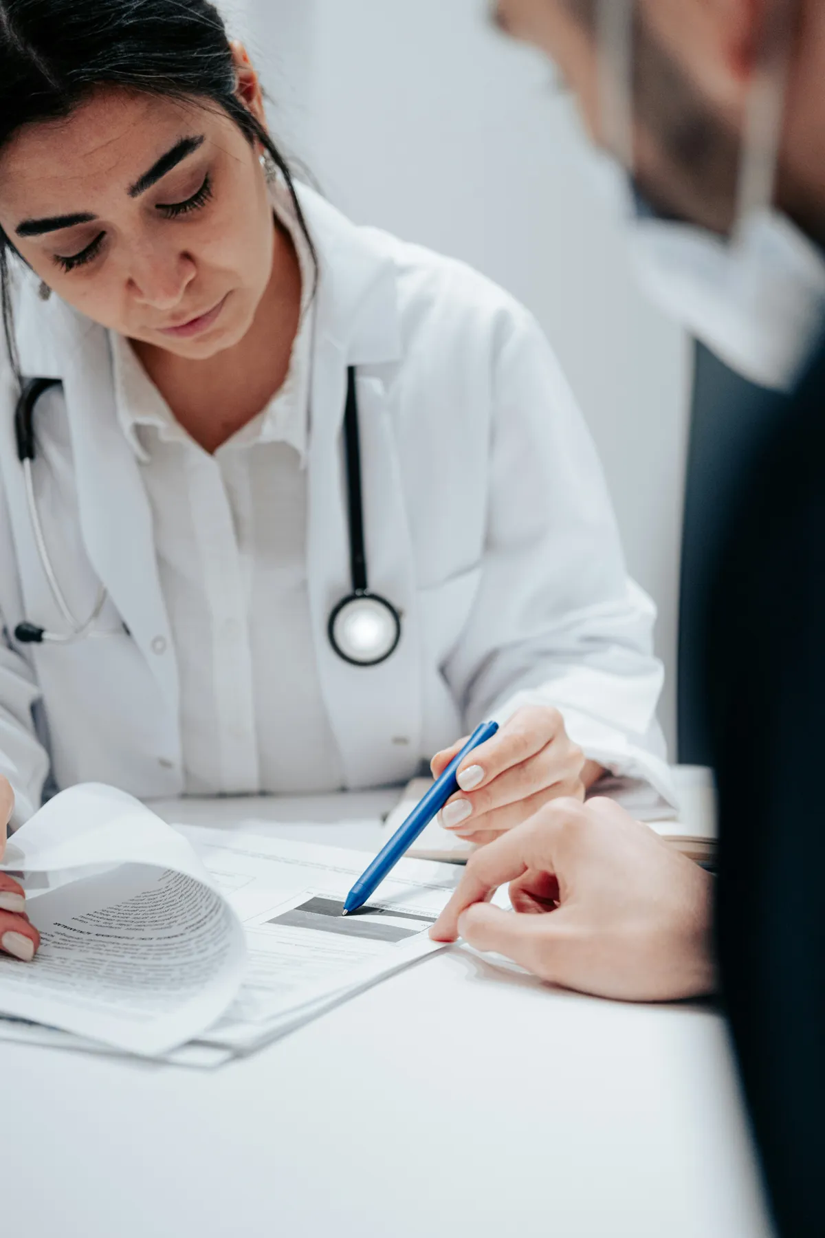 Doctor reviewing medical documents with a patient