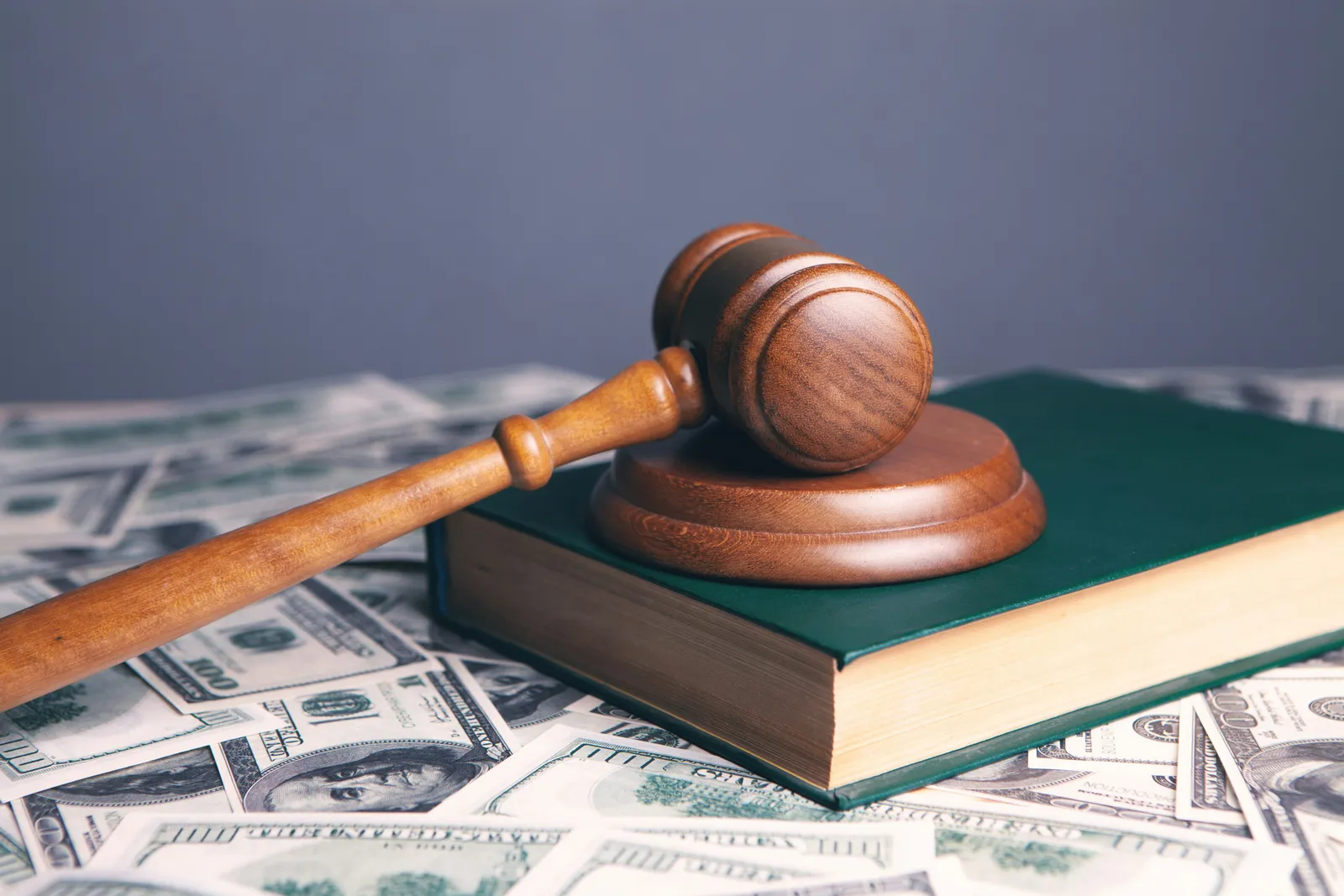 Judge gavel on legal book and money